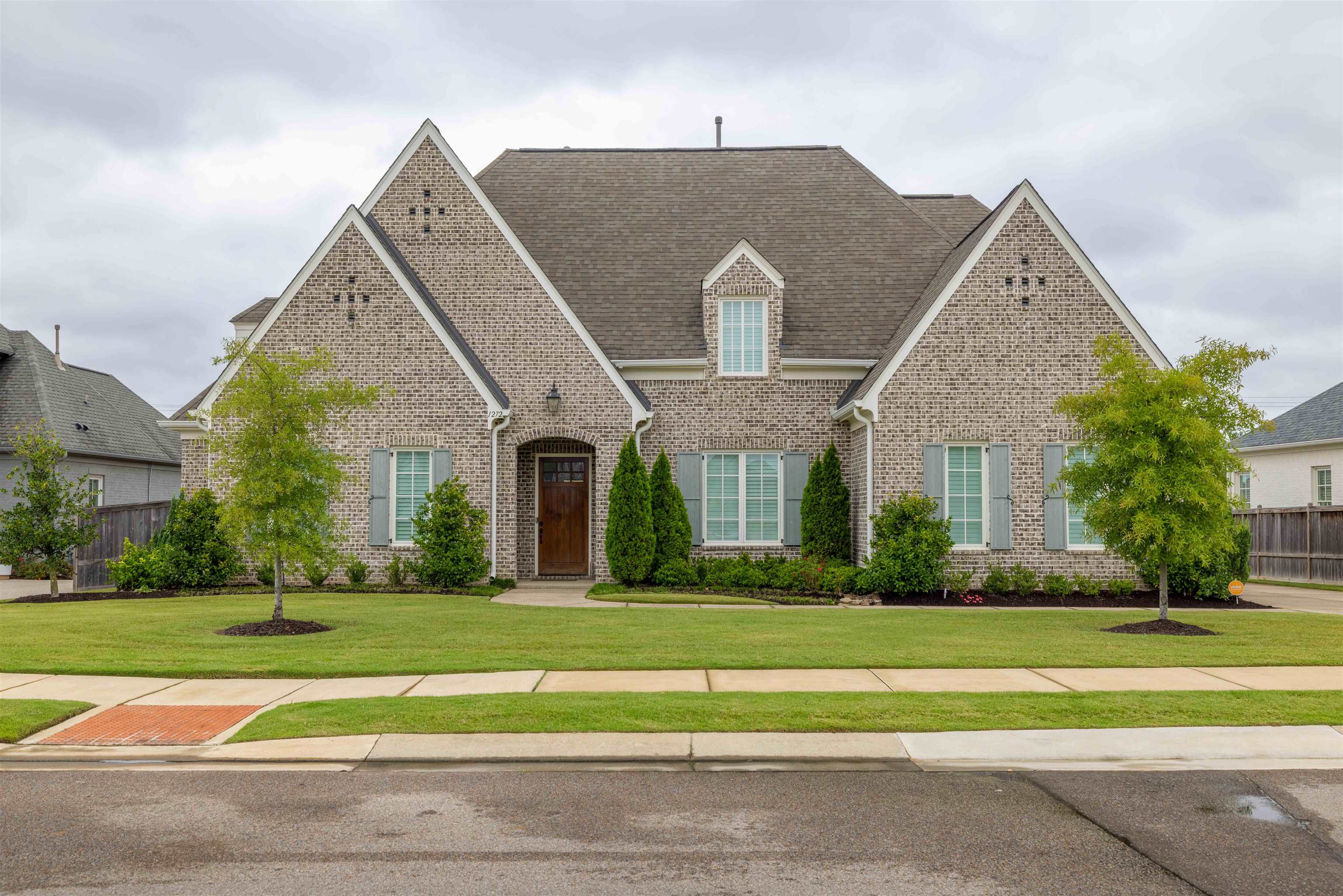 a front view of house with yard and green space