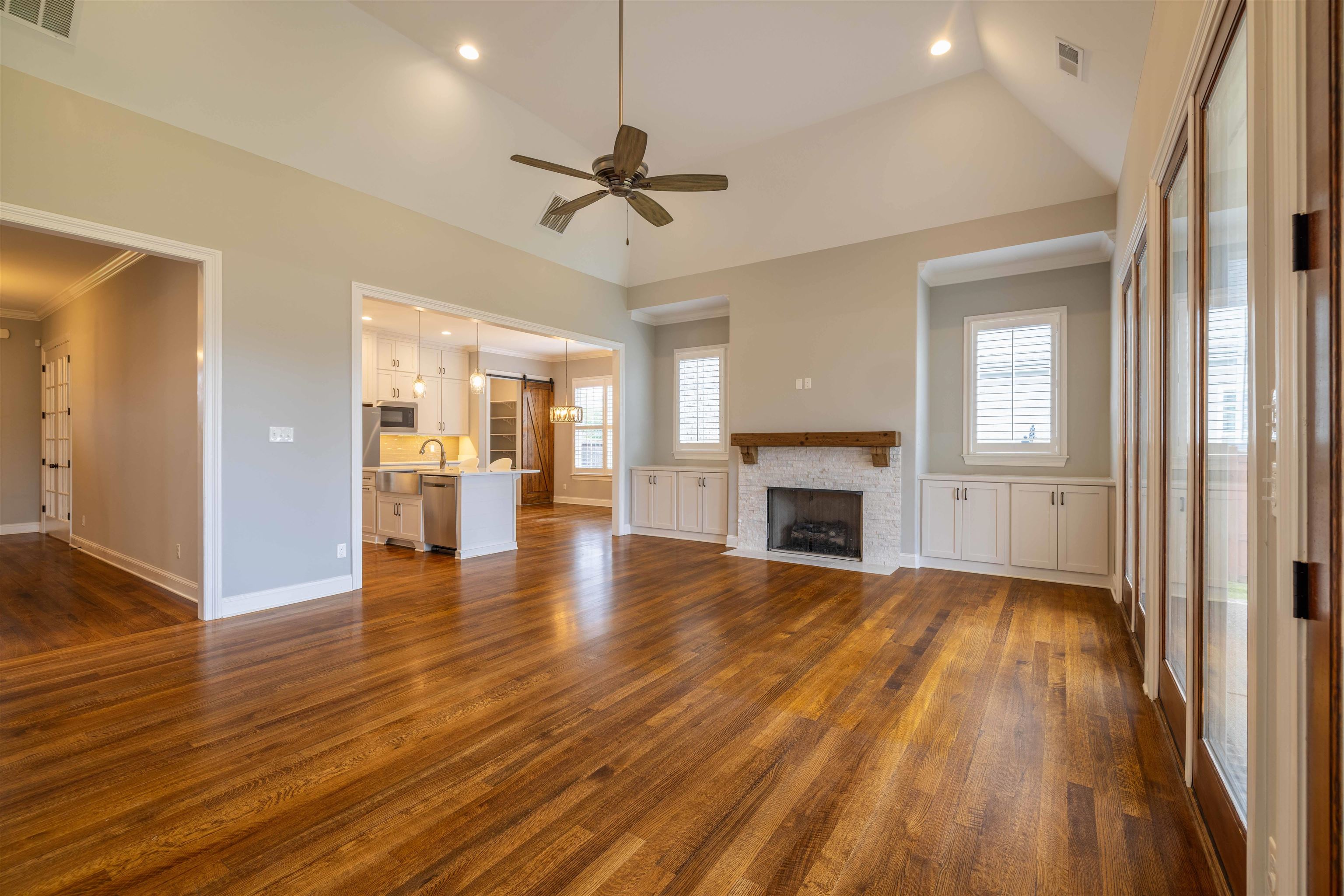1272 Percheron Pass Collierville, TN 38017 - Photo 5 of 24 a view of a livingroom with wooden floor a ceiling fan and windows