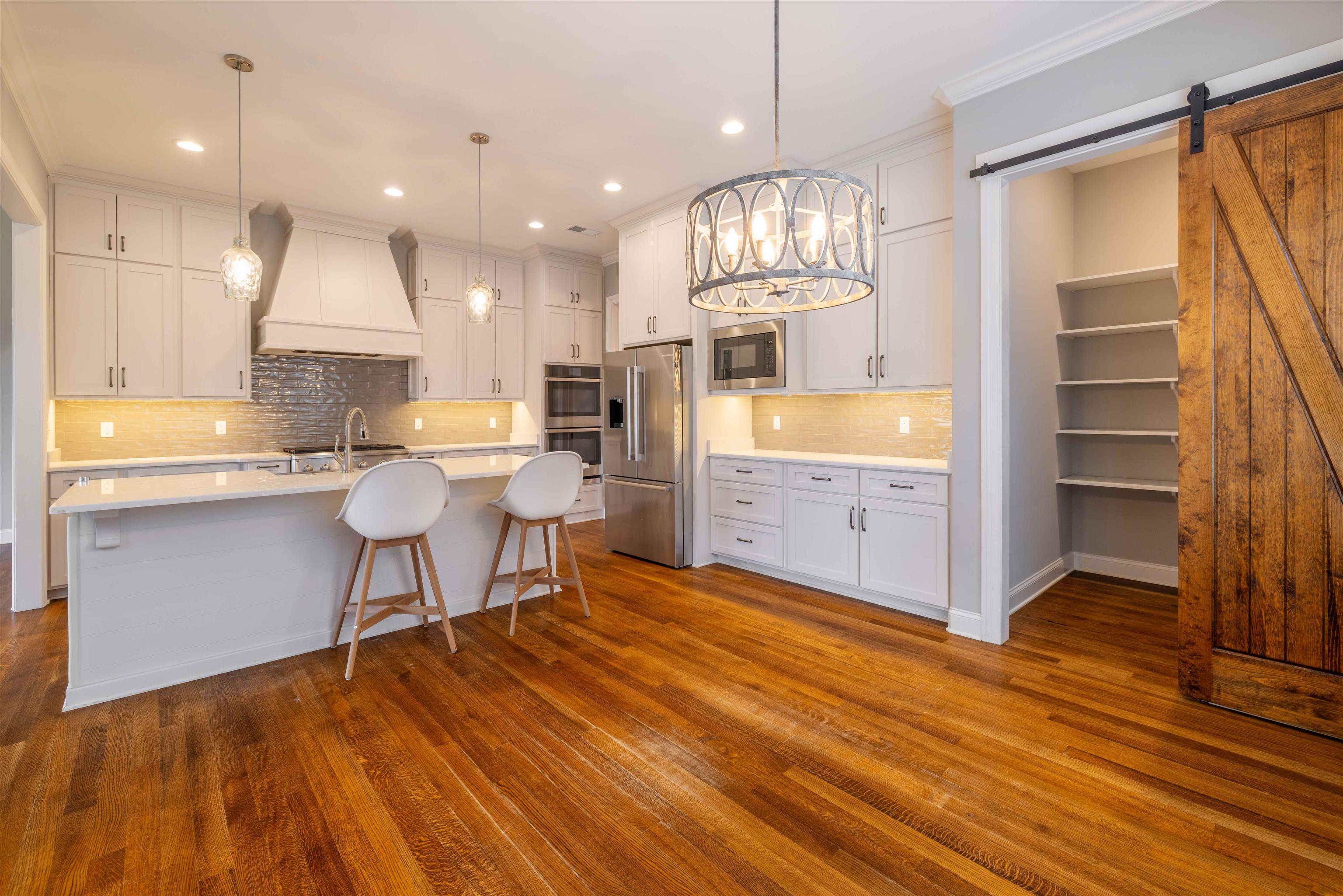 1272 Percheron Pass Collierville, TN 38017 - Photo 7 of 24 a view of kitchen and dining room with wooden floor