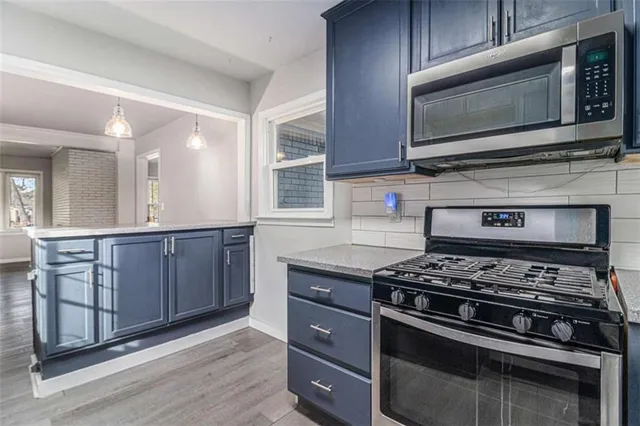 a kitchen with wooden cabinets and a stove top oven