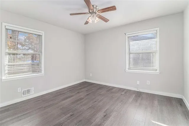 a view of a room with wooden floor and windows