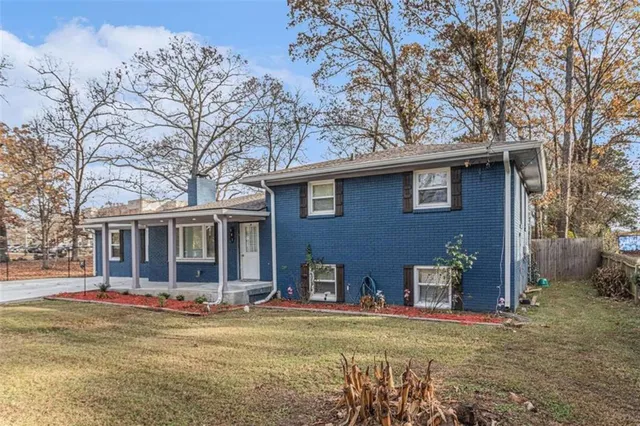 a front view of a house with a garden