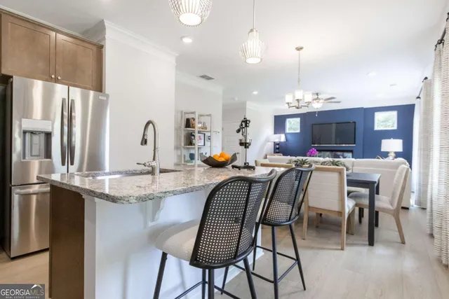 a view of dining room and kitchen island with furniture