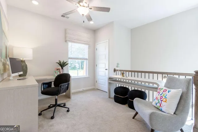 a view of a livingroom with workspace and a couch