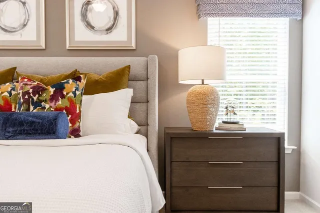 a bedroom with a bed and cabinet