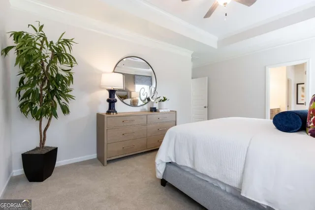a bedroom with a bed and a potted plant