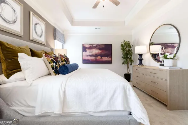 a bedroom with bed and a potted plant