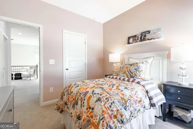 a bedroom with a bed and a mirror