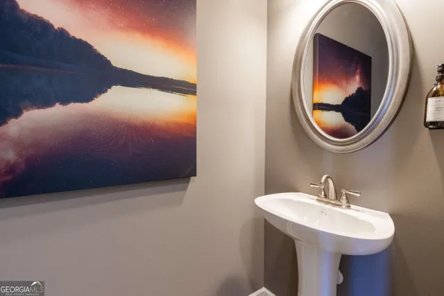 a bathroom with a sink and mirror