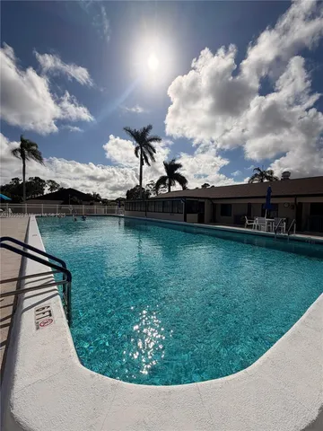 a view of a street with a cars parked on the road