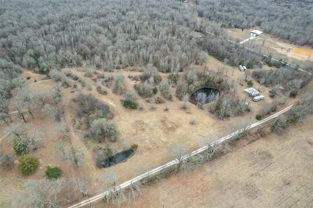 139 Northwest County Road, Unit 1061 Talco, TX 75487 - Photo 17 of 39 a view of a dry yard with wooden fence