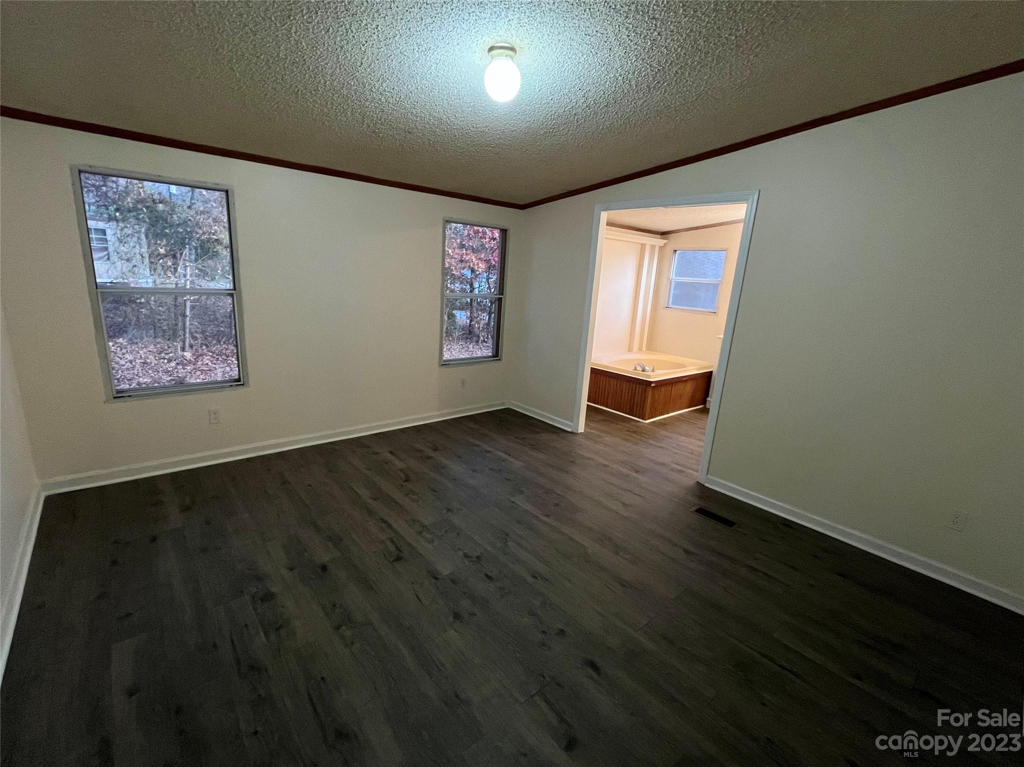 1631 Bethel Road Morganton, NC 28655 - Photo 7 of 17 a view of an empty room with wooden floor and a window