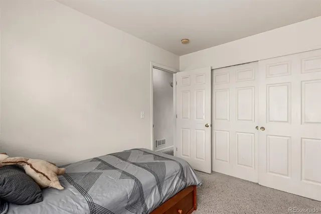 a bedroom with a bed and a table