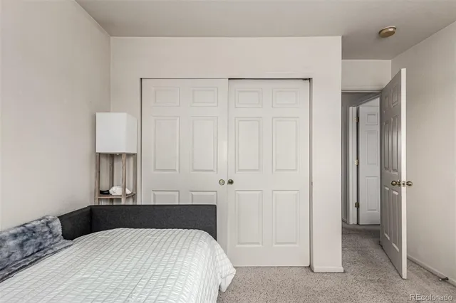 a bedroom with a bed a desk and a chair