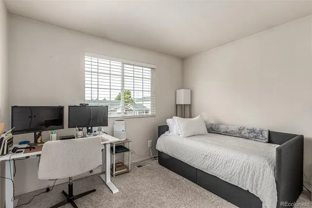 a bathroom with a granite countertop toilet sink and mirror