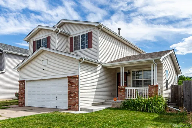 a front view of house with a garden