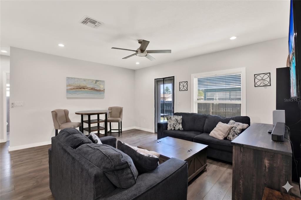 3023 Muir Street Holiday, FL 34691 - Photo 12 of 25 a living room with furniture a ceiling fan and a window