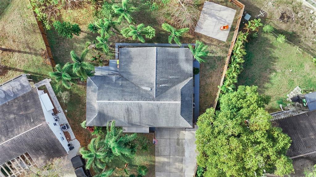 3849 Edgemont Drive New Port Richey, FL 34652 - Photo 12 of 43 an aerial view of a house with a yard and large trees