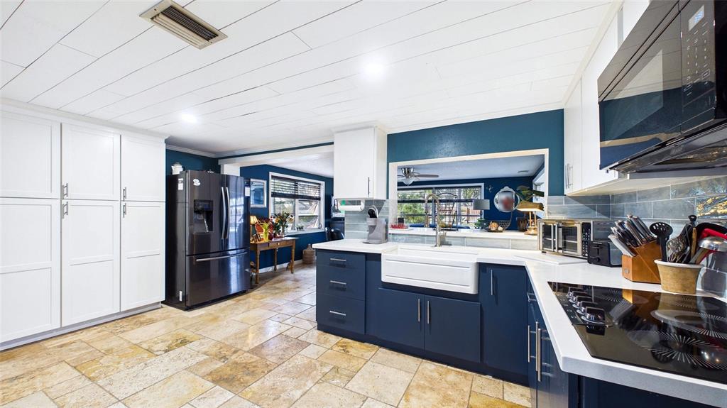3849 Edgemont Drive New Port Richey, FL 34652 - Photo 20 of 43 a kitchen with stainless steel appliances granite countertop a refrigerator and a stove top oven