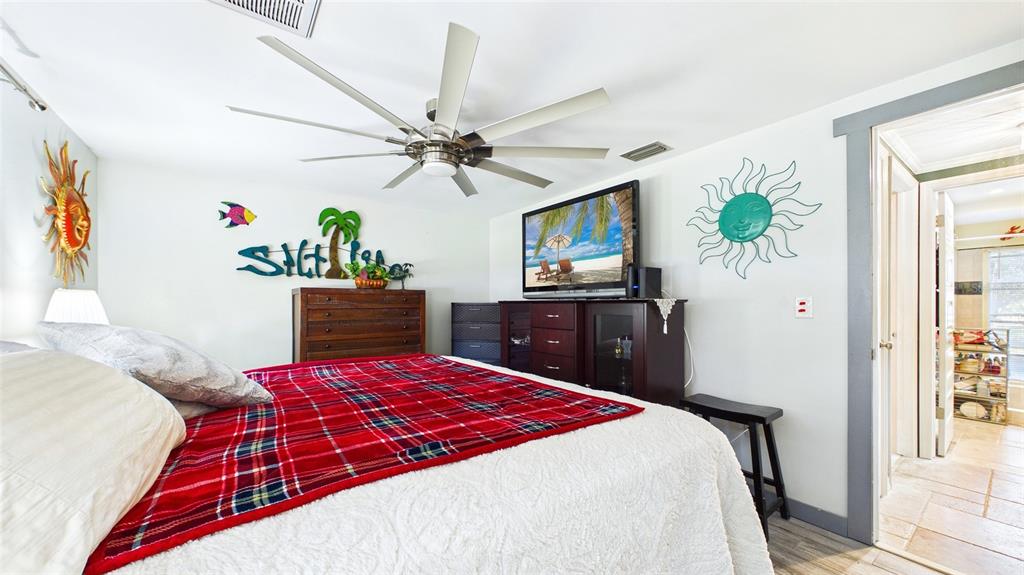 3849 Edgemont Drive New Port Richey, FL 34652 - Photo 29 of 43 a bedroom with a bed dresser and a window