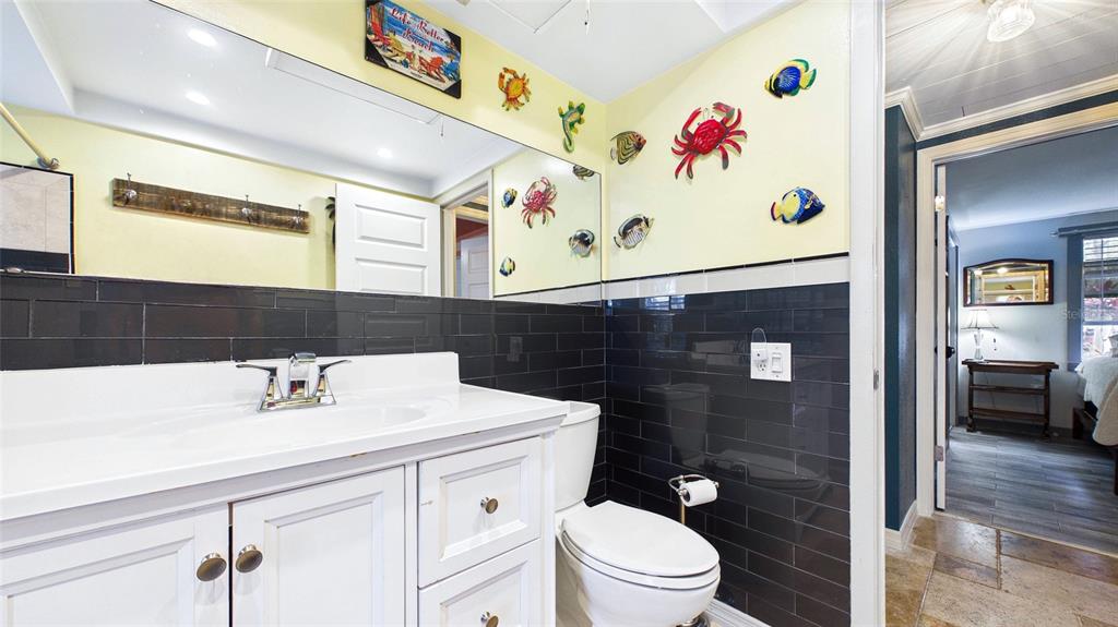 3849 Edgemont Drive New Port Richey, FL 34652 - Photo 32 of 43 a bathroom with a toilet a sink and mirror