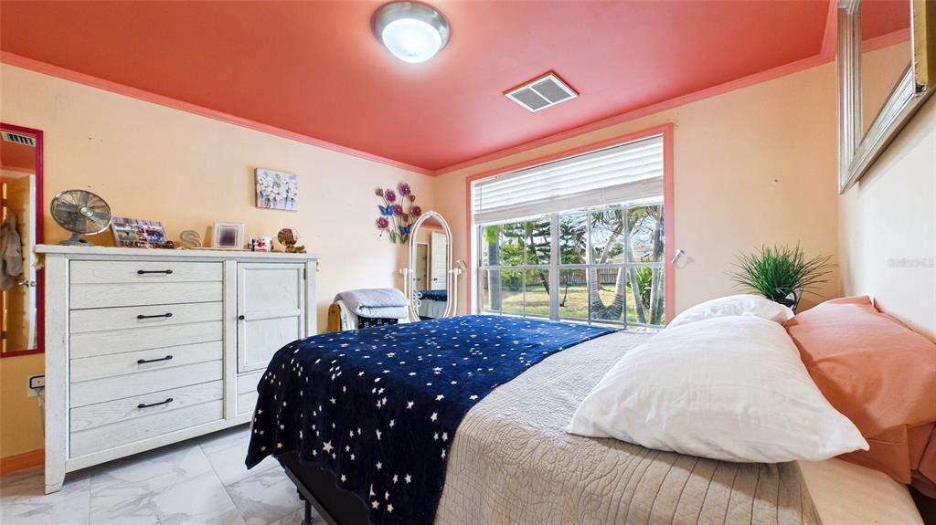 3849 Edgemont Drive New Port Richey, FL 34652 - Photo 33 of 43 a bedroom with a bed and a window