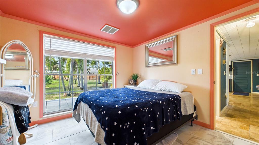 3849 Edgemont Drive New Port Richey, FL 34652 - Photo 34 of 43 a bedroom with a bed and a window