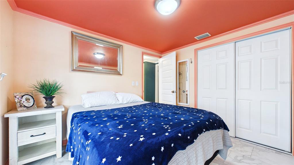 3849 Edgemont Drive New Port Richey, FL 34652 - Photo 35 of 43 a bedroom with a large bed and a dresser