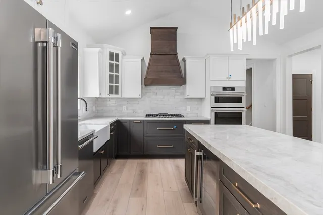 a kitchen with a sink stove and refrigerator