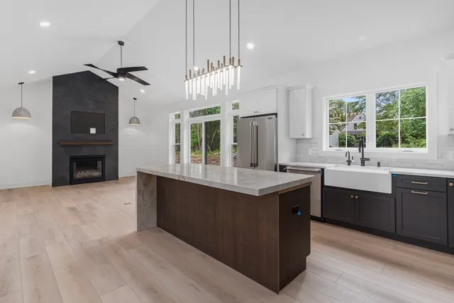 a kitchen with granite countertop a sink cabinets and window