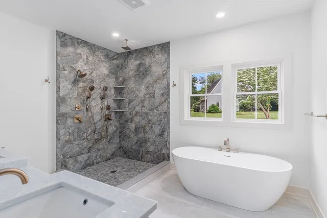 a bathroom with a bathtub and shower