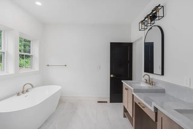 a bathroom with a double vanity sink and a bathtub
