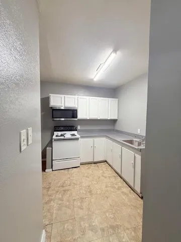a kitchen with stainless steel appliances a refrigerator and a stove top oven