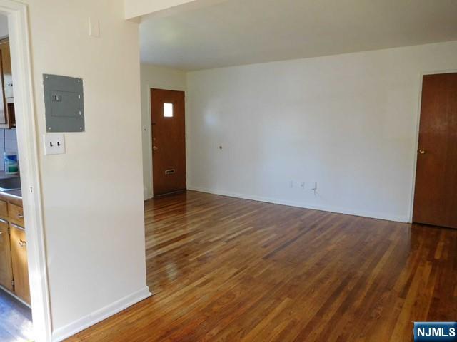 401 West Madison Avenue, Unit 7 Dumont, NJ 07628 - Photo 4 of 10 a view of an empty room with wooden floor and a window