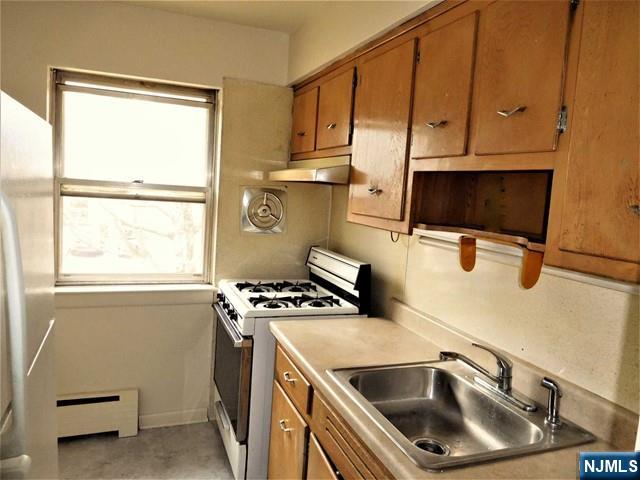401 West Madison Avenue, Unit 7 Dumont, NJ 07628 - Photo 6 of 10 a kitchen with a stove and a sink
