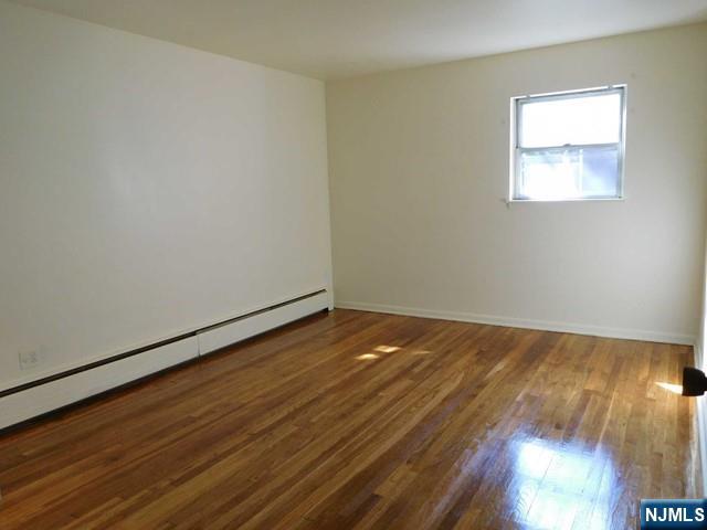 401 West Madison Avenue, Unit 7 Dumont, NJ 07628 - Photo 7 of 10 a view of empty room with wooden floor
