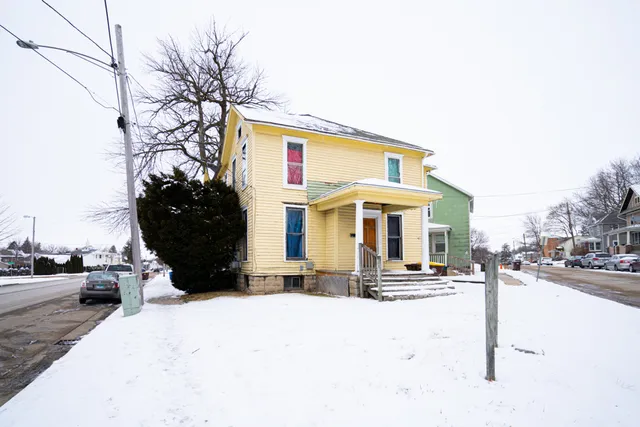a view of a building with cars parked