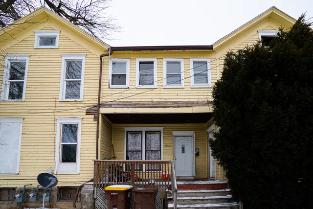 a front view of a house with outdoor seating