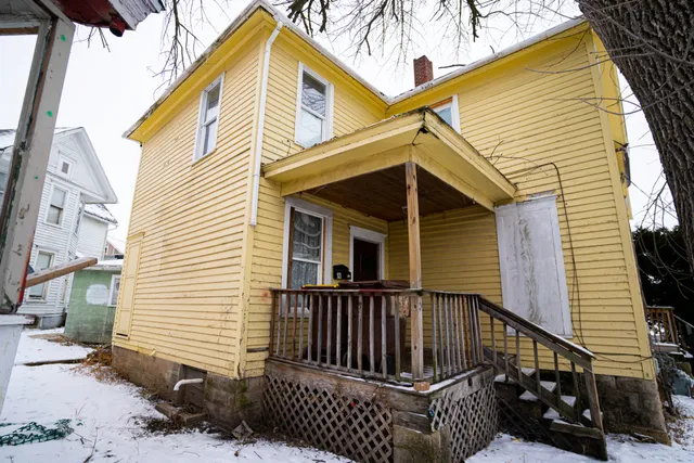 a view of a house with wooden fence