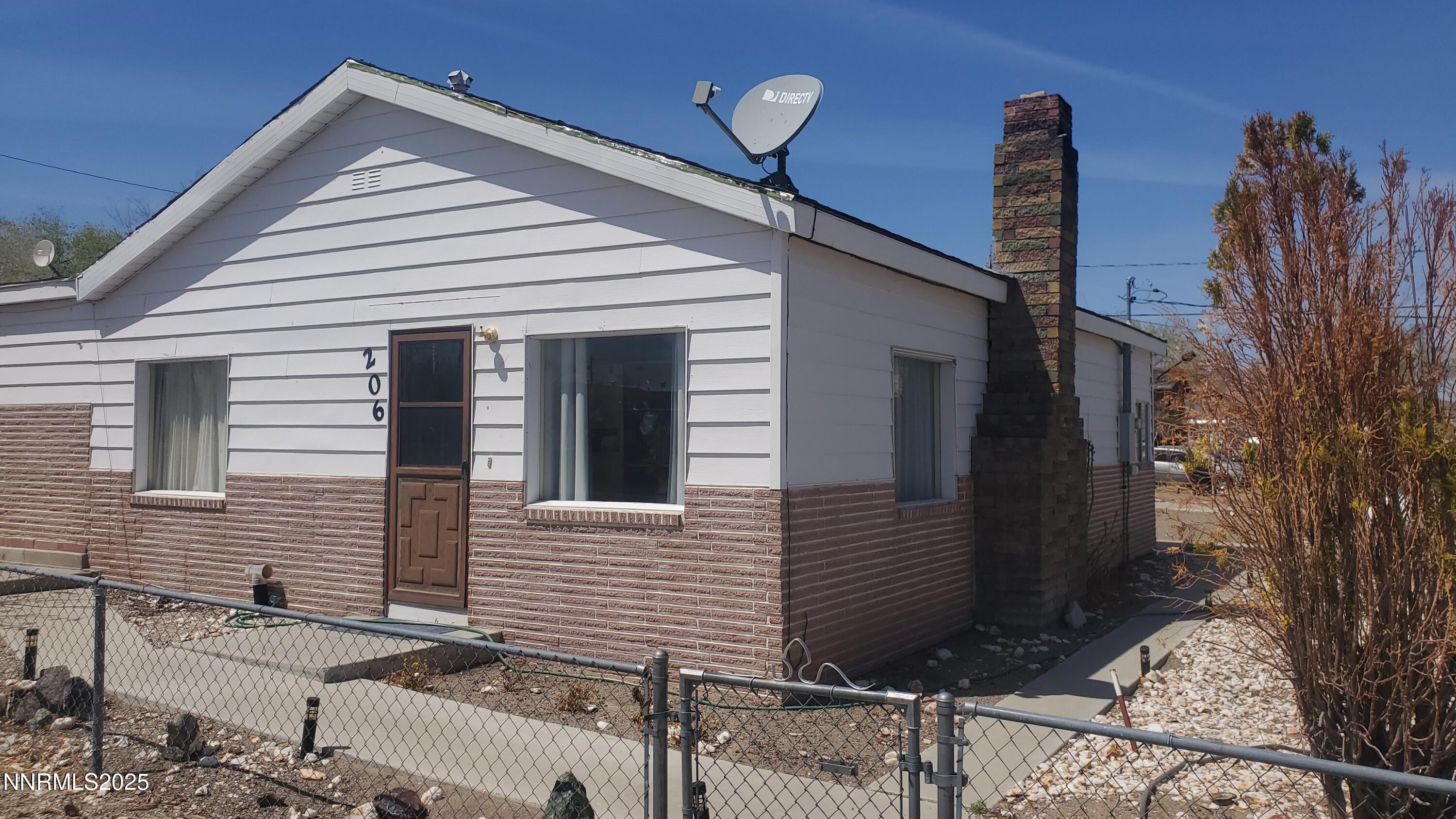 206 12th Street Mina, NV 89422 - Photo 2 of 7 a view of a house with a yard