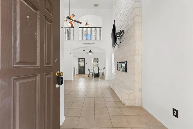 a view of a hallway with a white walls and stairs