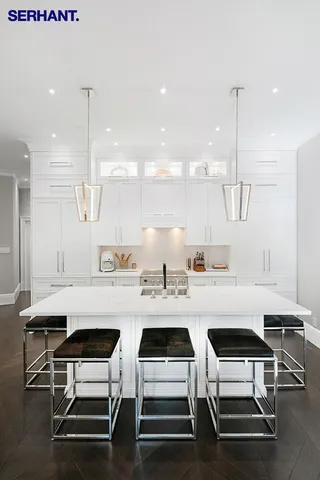 a kitchen with a sink a stove and chairs