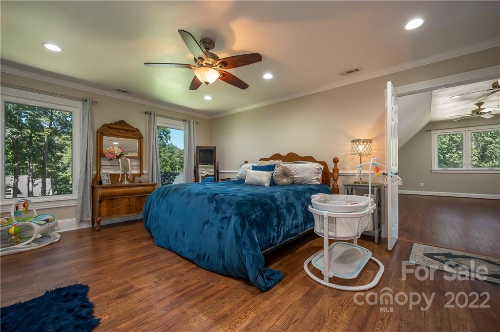106 Gray Court Rutherfordton, NC 28139 - Photo 8 of 46 a spacious bedroom with a bed and wooden floor