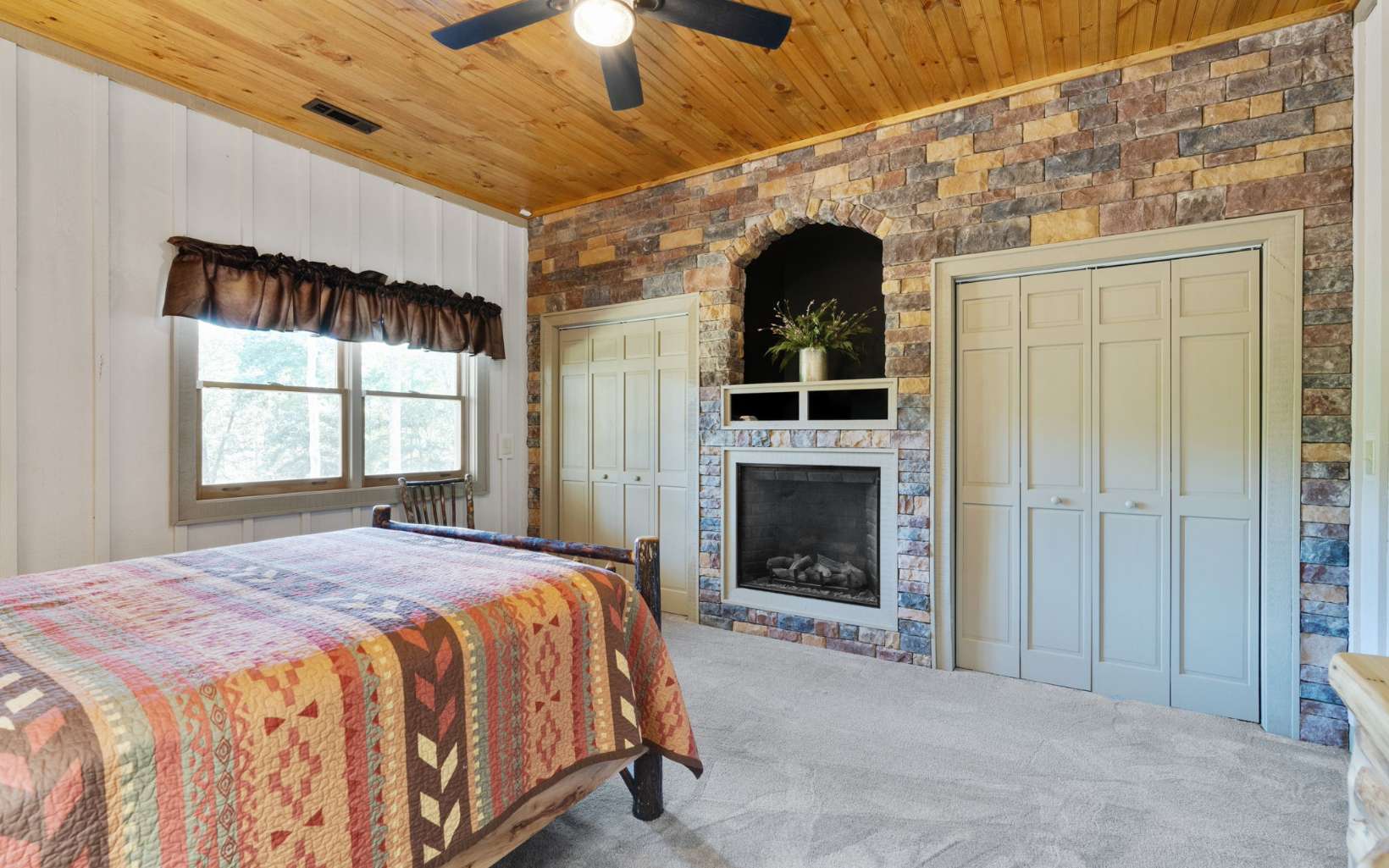 42 Overlook Road Blue Ridge, GA 30513 - Photo 32 of 63 a spacious bedroom with a bed and a fireplace