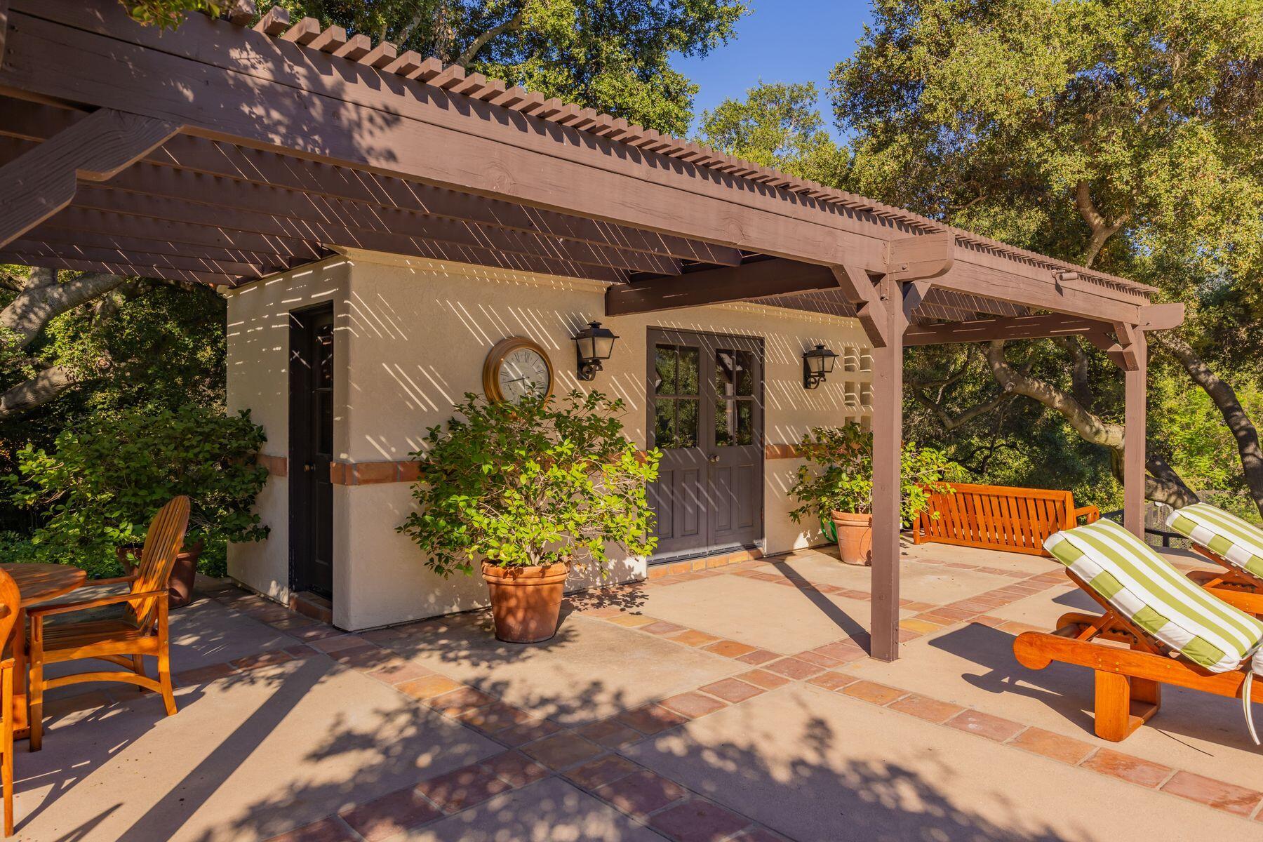 10883 Oak Knoll Road Ojai, CA 93023 - Photo 14 of 43 a view of a patio with table and chairs and potted plants