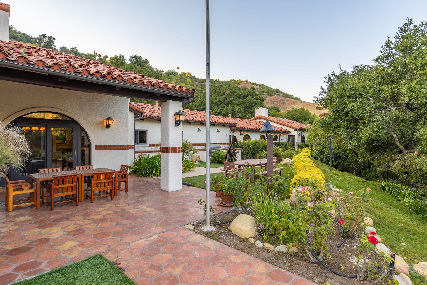 10883 Oak Knoll Road Ojai, CA 93023 - Photo 16 of 43 a view of a chairs and table in backyard