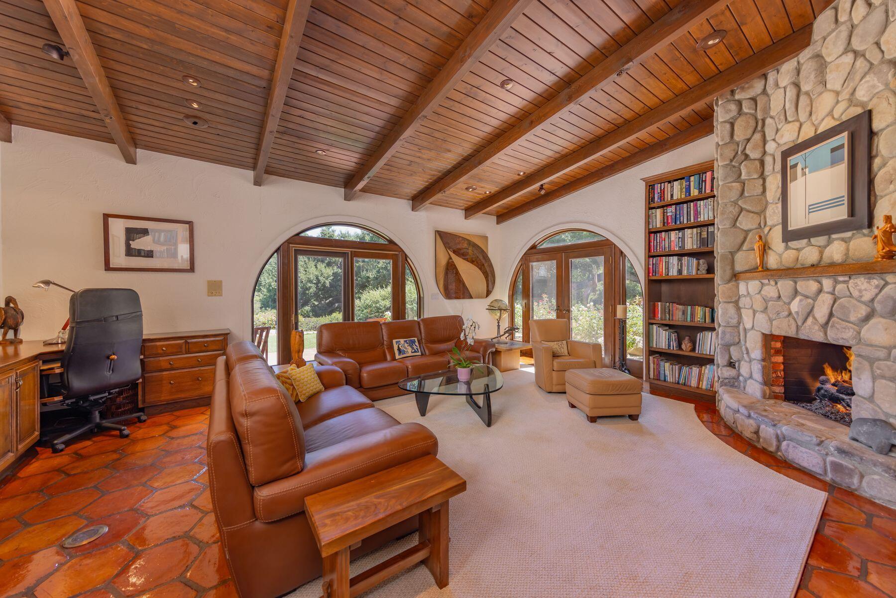 10883 Oak Knoll Road Ojai, CA 93023 - Photo 27 of 43 a living room with furniture fireplace and a fireplace