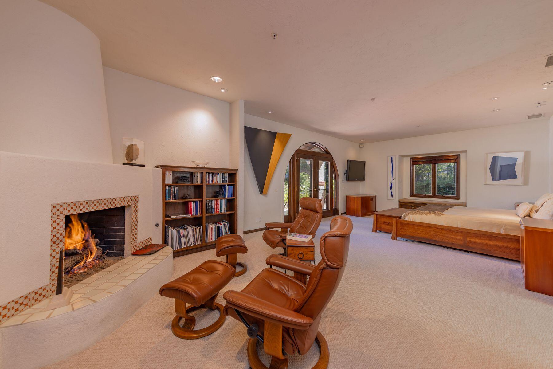 10883 Oak Knoll Road Ojai, CA 93023 - Photo 29 of 43 a living room with furniture gym equipment and a fireplace