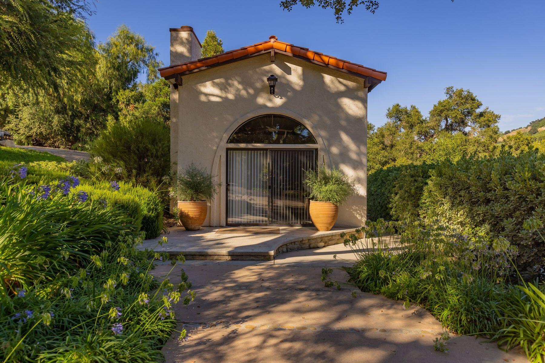 10883 Oak Knoll Road Ojai, CA 93023 - Photo 31 of 43 a front view of a house with a yard