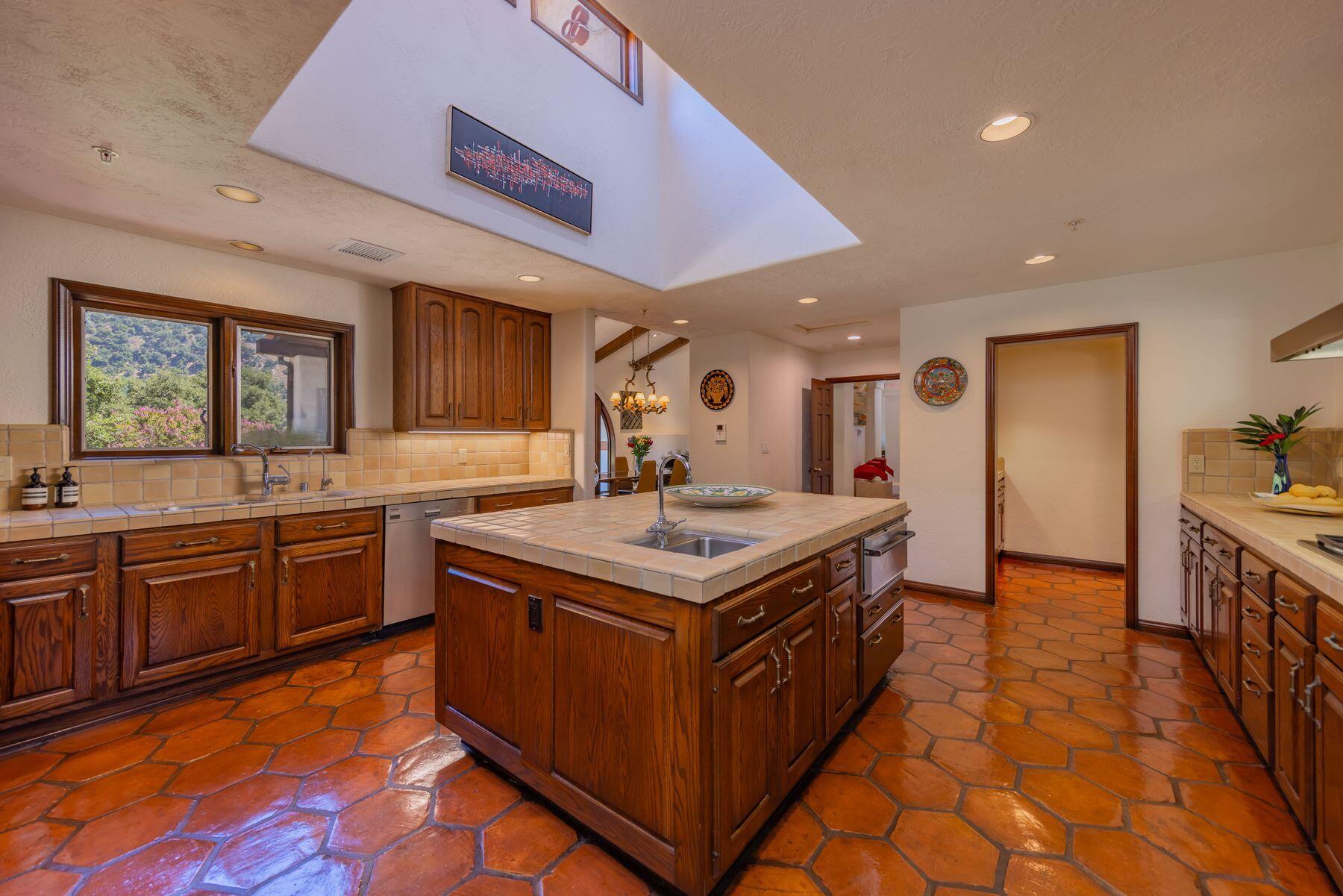 10883 Oak Knoll Road Ojai, CA 93023 - Photo 34 of 43 a kitchen with a stove top oven sink and cabinets